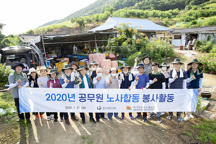 2020년 공무원 노사합동 봉사활동 현수막을 들고 단체 사진을 촬영하는 봉사자들과 농민들