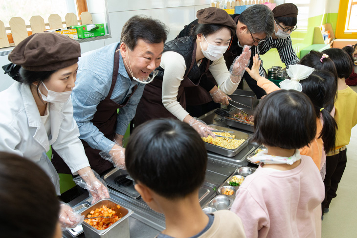 어린이들의 급식 배식을 도우며 미소 짓고 있는 황서종 인사혁신처장